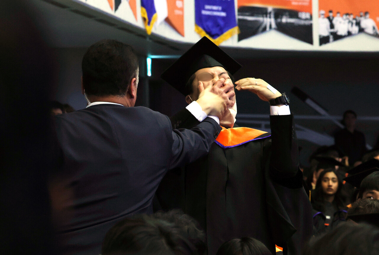 대전 유성구 카이스트(KAIST)에서 열린 2024년 학위수여식에서 한 석사 졸업생이 축사 중인 윤석열 대통령에게 R&D 예산 복원 등을 요구하며 자리에서 일어나 항의하다 제지 당하고 있다. 2024.02.16./자료사진=뉴시스